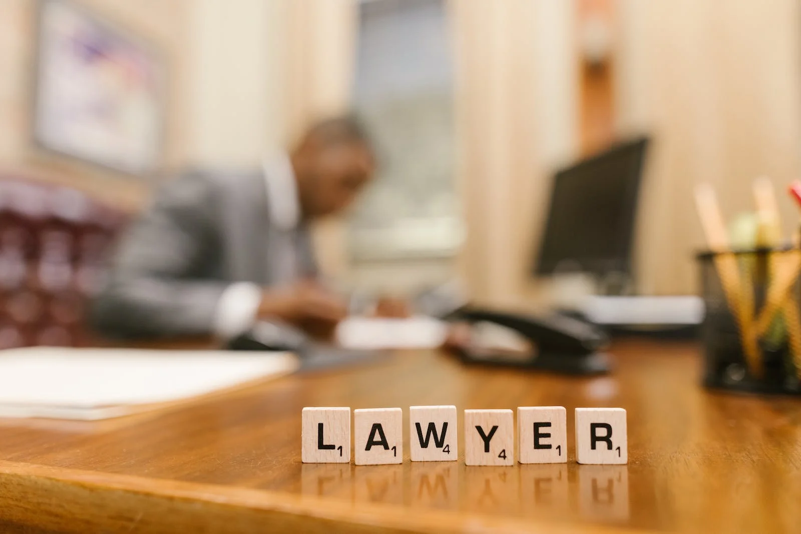 Scrabble letters spelling LAWYER