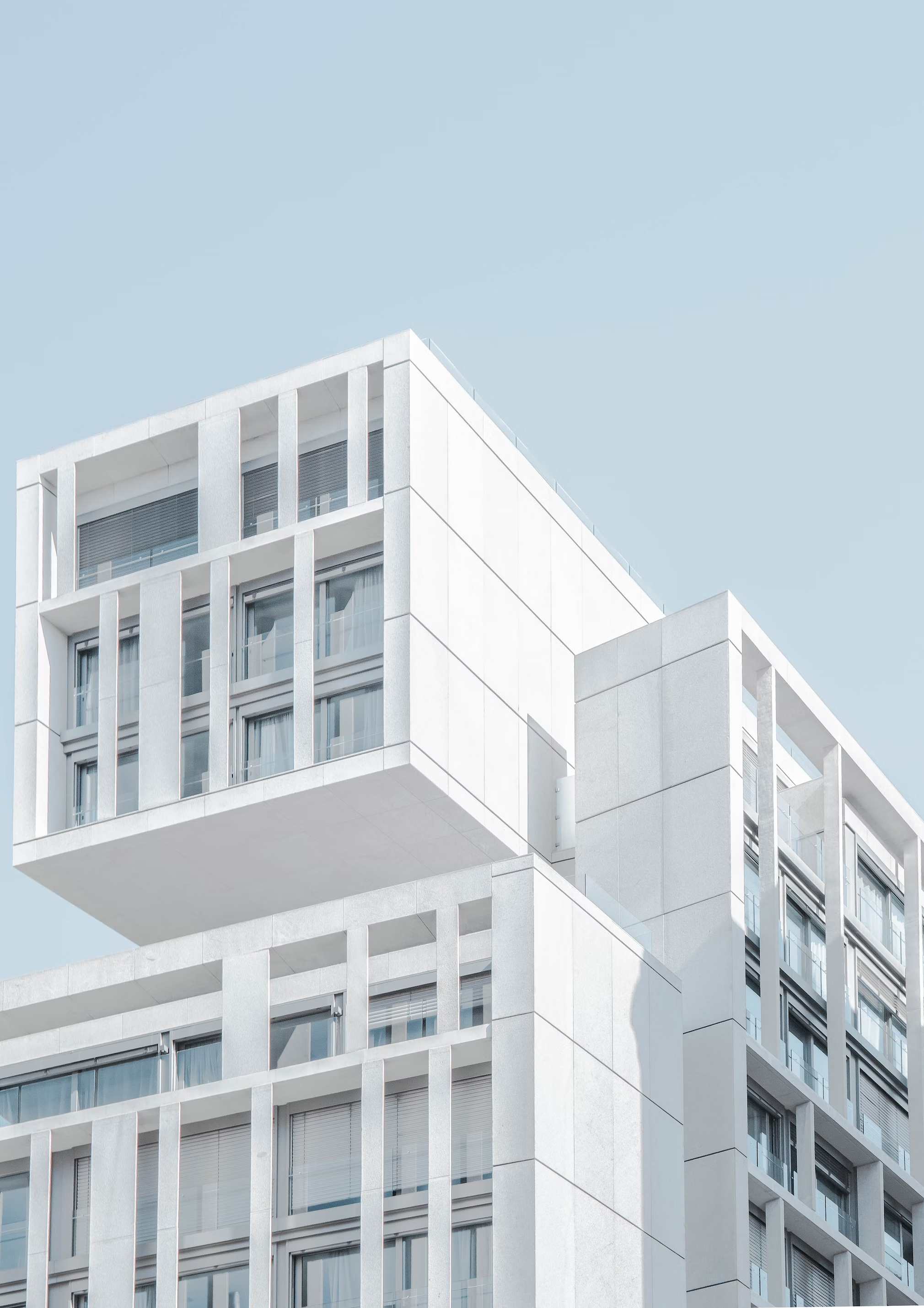 A modern residential building with a geometric facade.