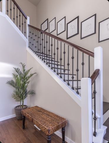 A staircase with a decorative wrought iron railing