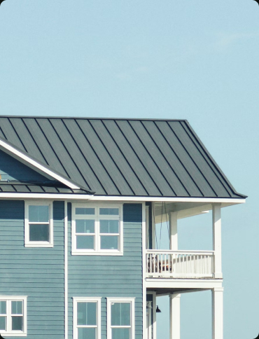 A blue two-story house with a porch